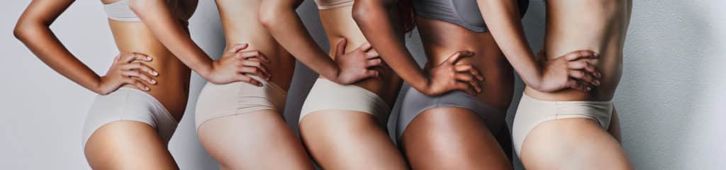 women in bikinis in a line posing for the camera