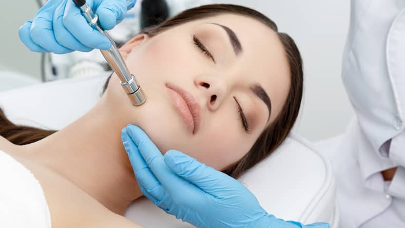 woman undergoing microdermabrasion treatment