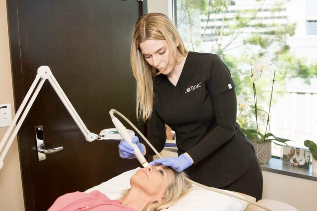 woman micro-needling a patient  